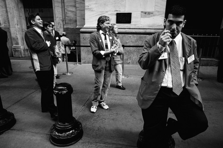 Traders take a break outside The New York Stock Exchange on February 16, 1988