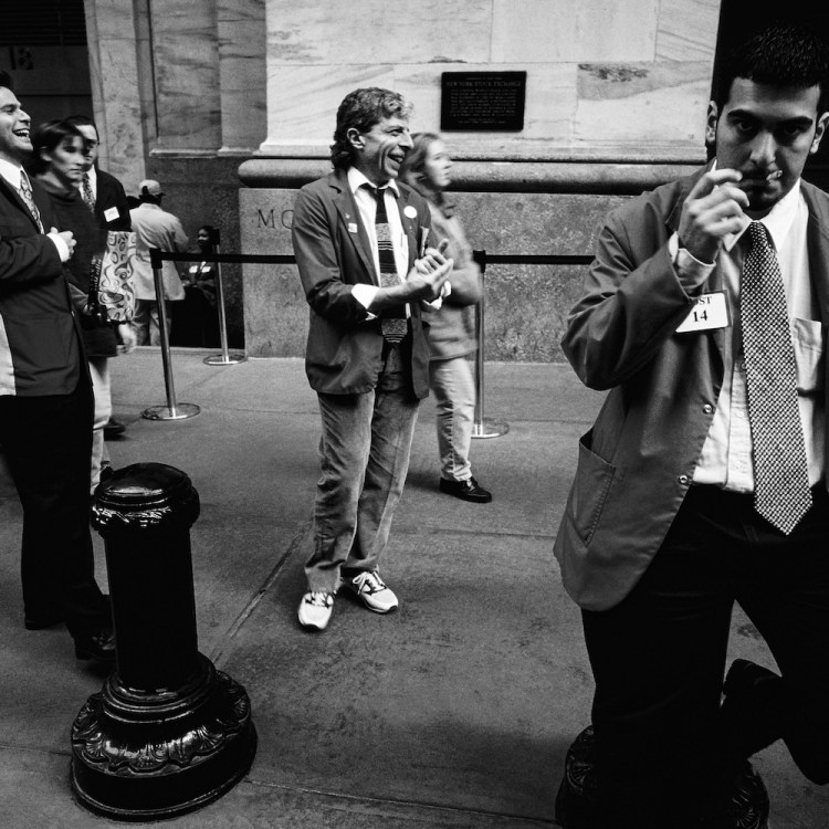 Traders take a break outside The New York Stock Exchange on February 16, 1988