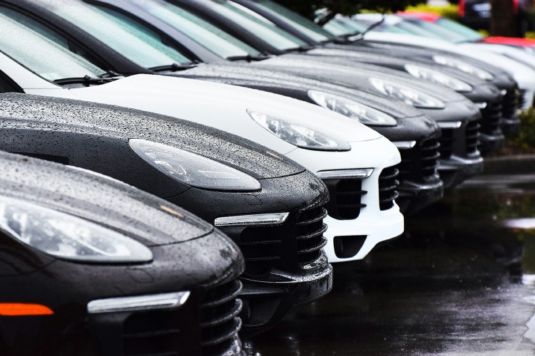 A row of Porsche Macan SUVs in the rain